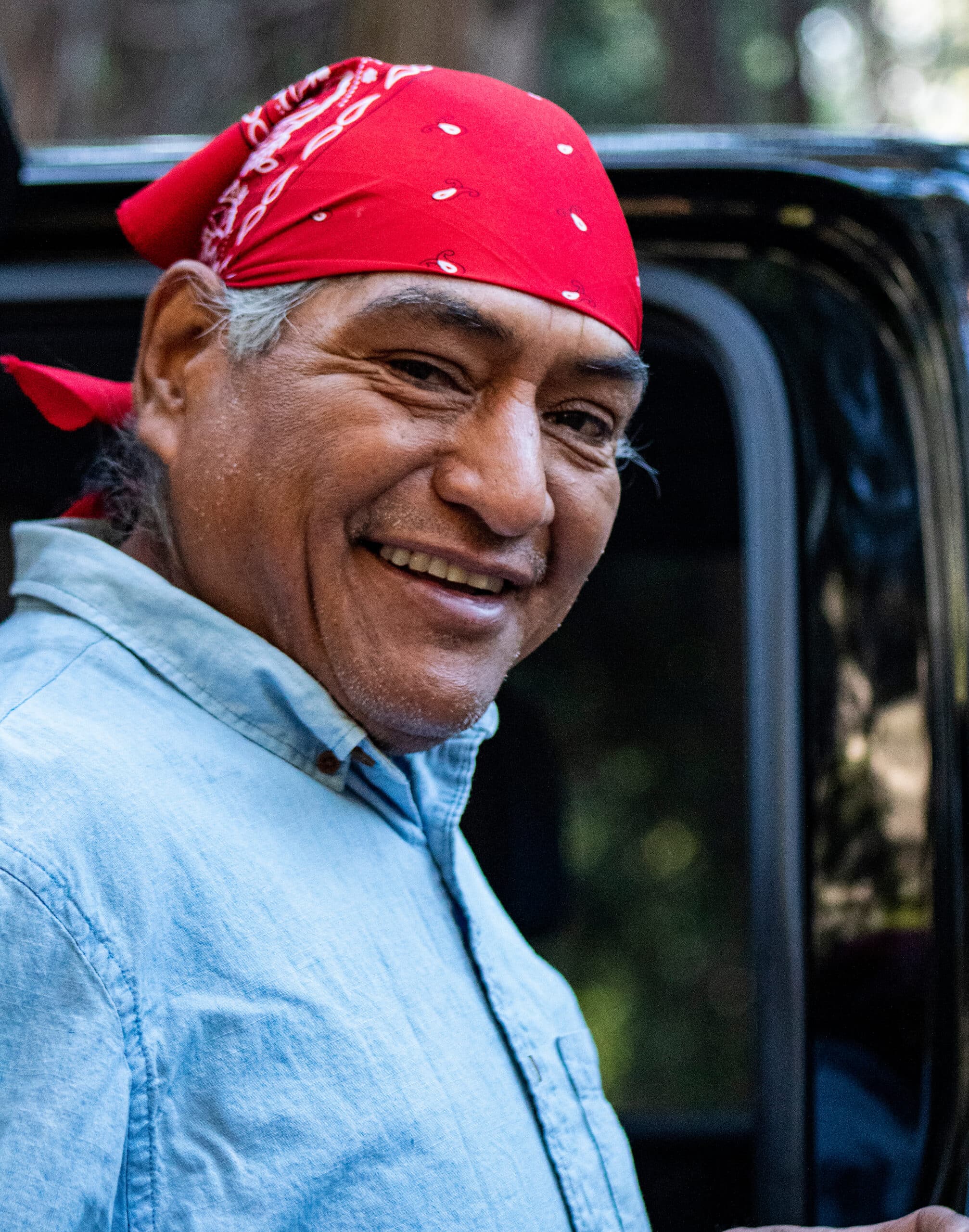 Native American Man Smiling with red bandana